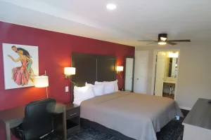 large king sized bed in red room at an inn